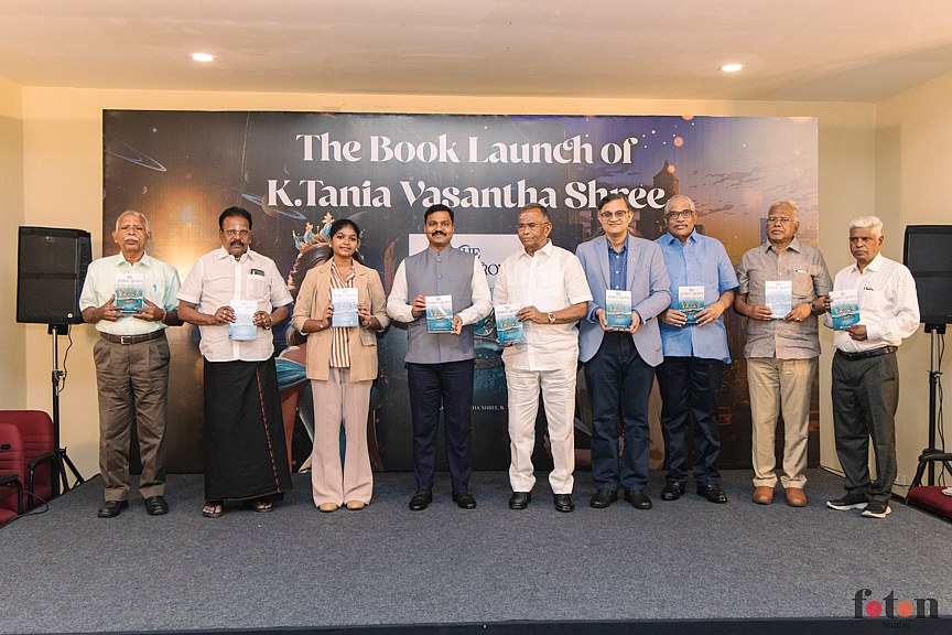 Dignitaries on stage holding the book